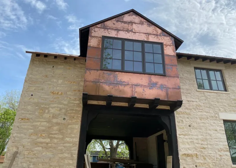 Copper metal panel facade on a stone building for Roof Repair in Lake Butler