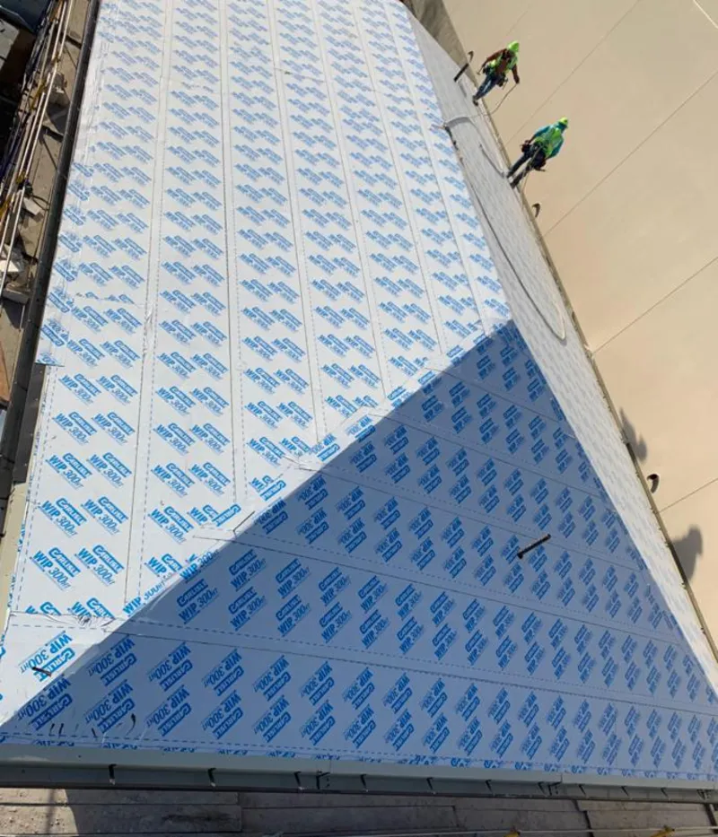 Professional roofers installing underlayment on a metal roof in Lake Butler